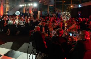 Guests seated round tables at Christmas Ball