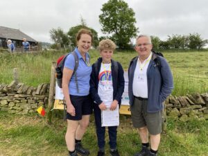 Woman, boy and man wearing hiking boots at Tegg's Nose country park