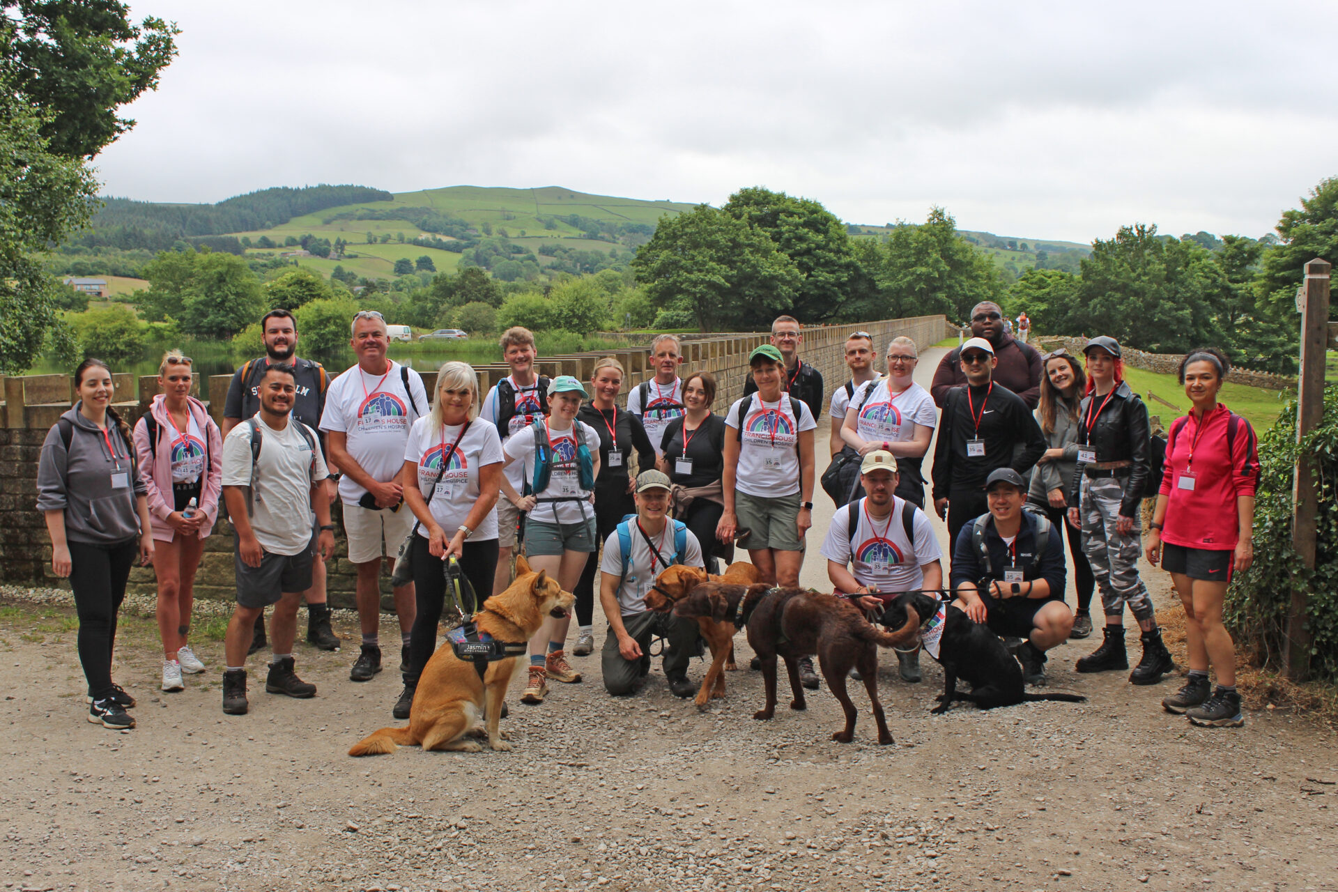 Large group of walkers and pet dogs stood at Tegg's Nose reservoir