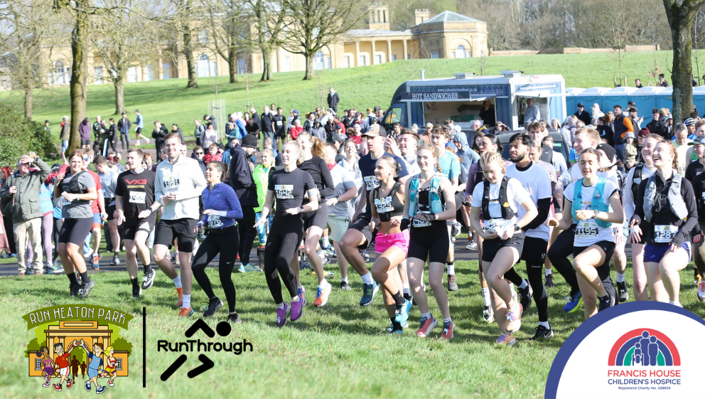 A big group of runners warm up against the backdrop of Heaton Park's hall